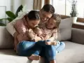 Rodzina przytula się na kanapie. Radość i miłość, jakby to były ich babciowe.
